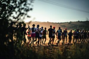 Ultra runners head through a field at Race to the Stones